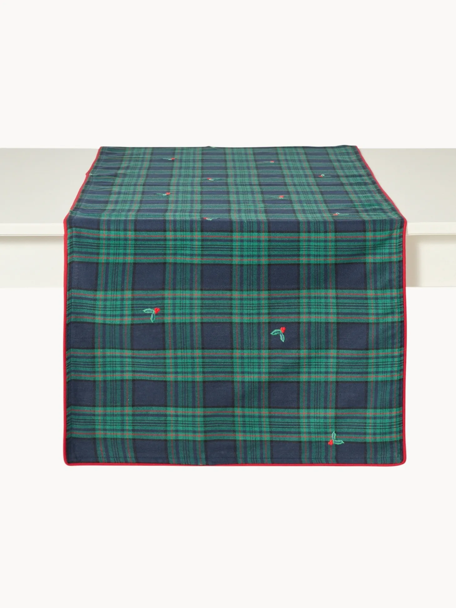 Tovaglietta tartan in twill di cotone con ricami agrifoglio e bordi smerlati